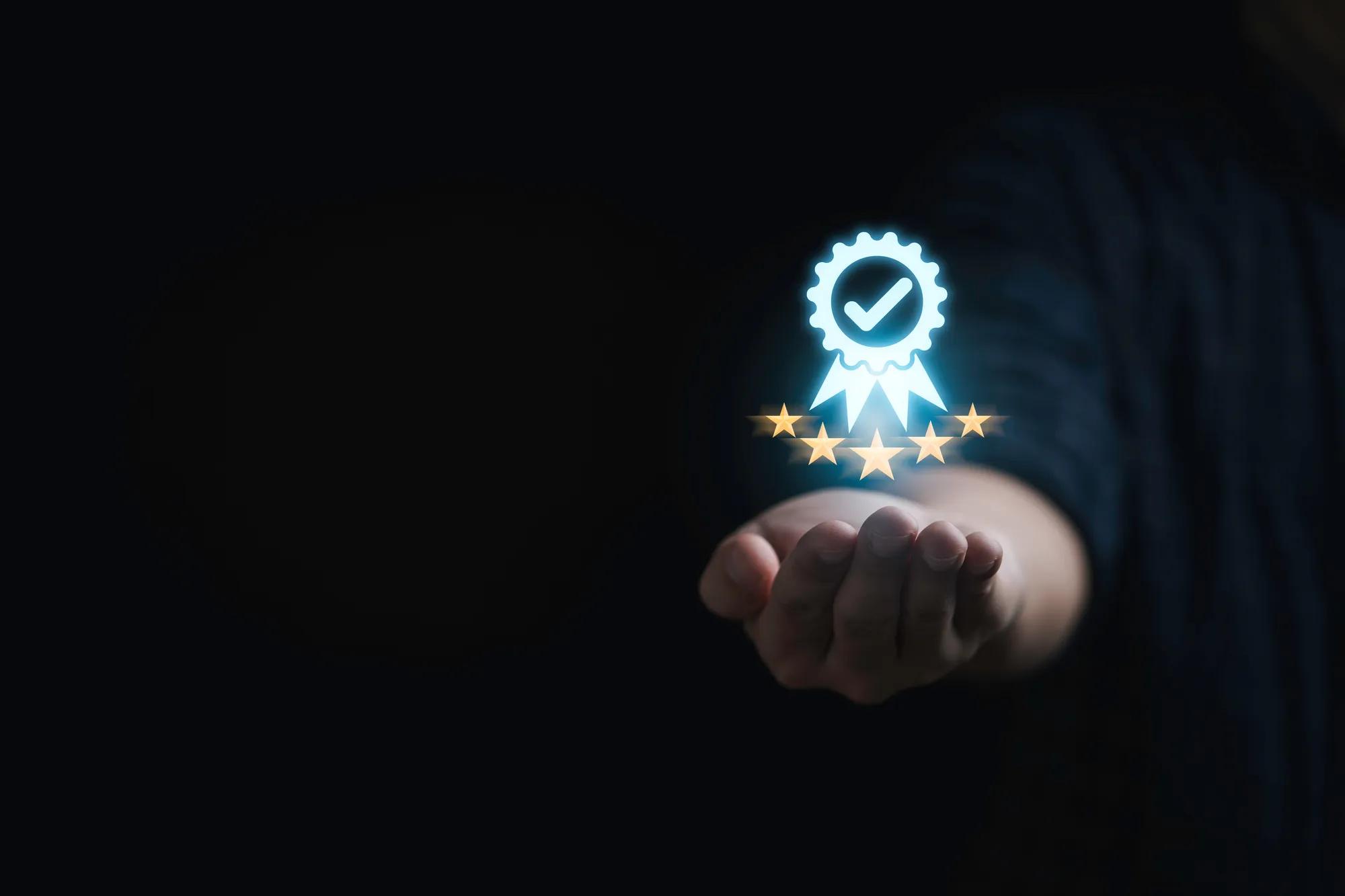 Businessman holding and showing the best quality assurance with golden five stars for guarantee product and ISO service concept.