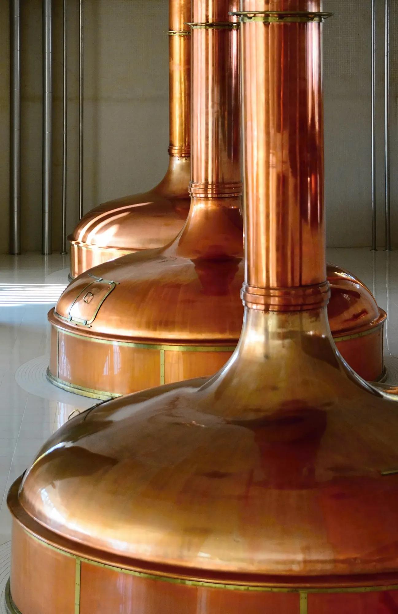 View of beer brewery interior with traditional fermenting copper vats.