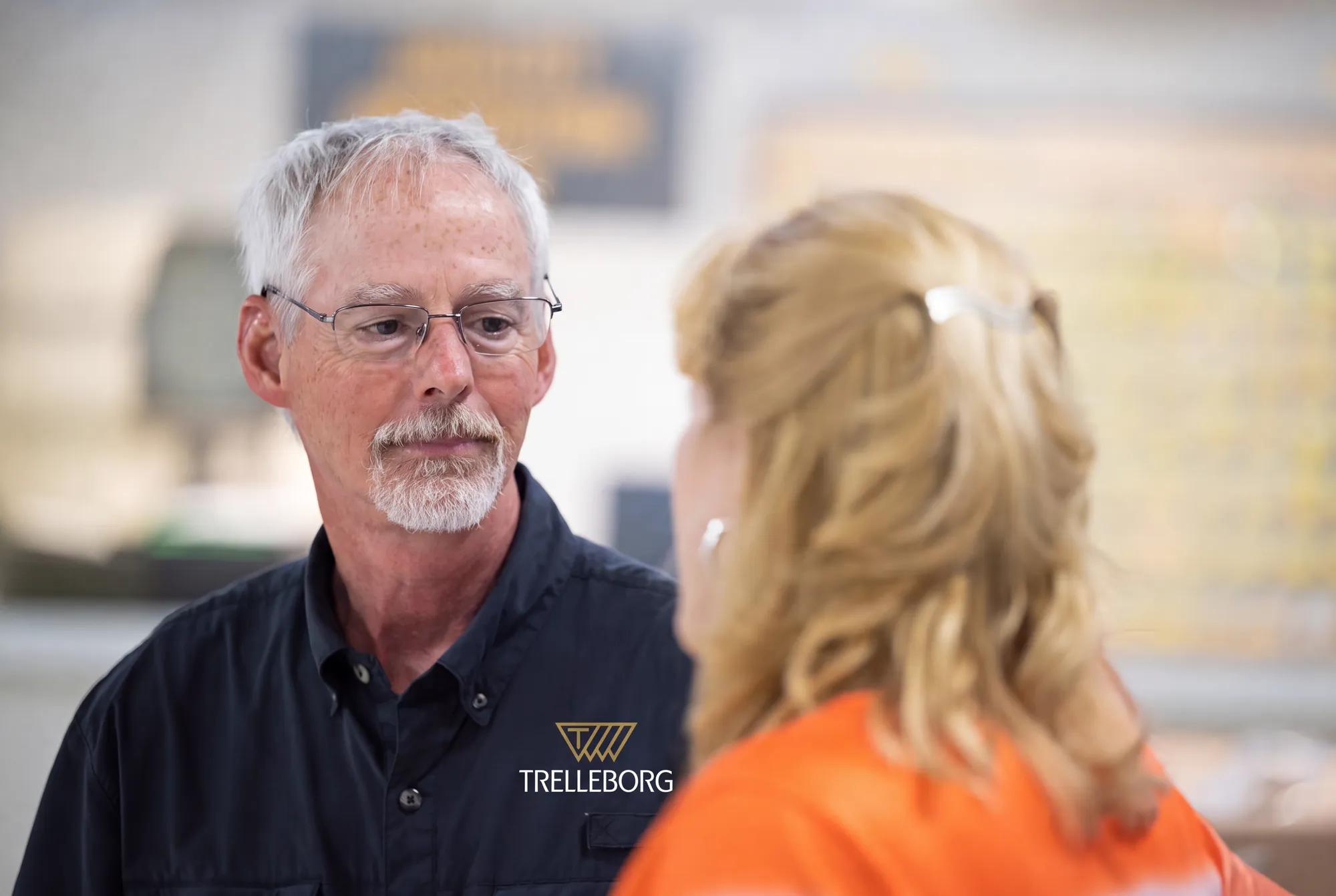 Two employees are discussing operations and collaboration at a Trelleborg manufacturing facility in the United States.