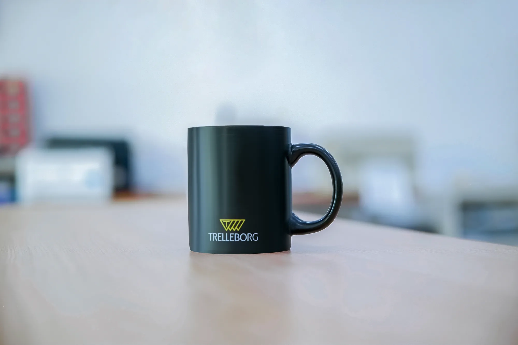 A Trelleborg branded coffee cup.