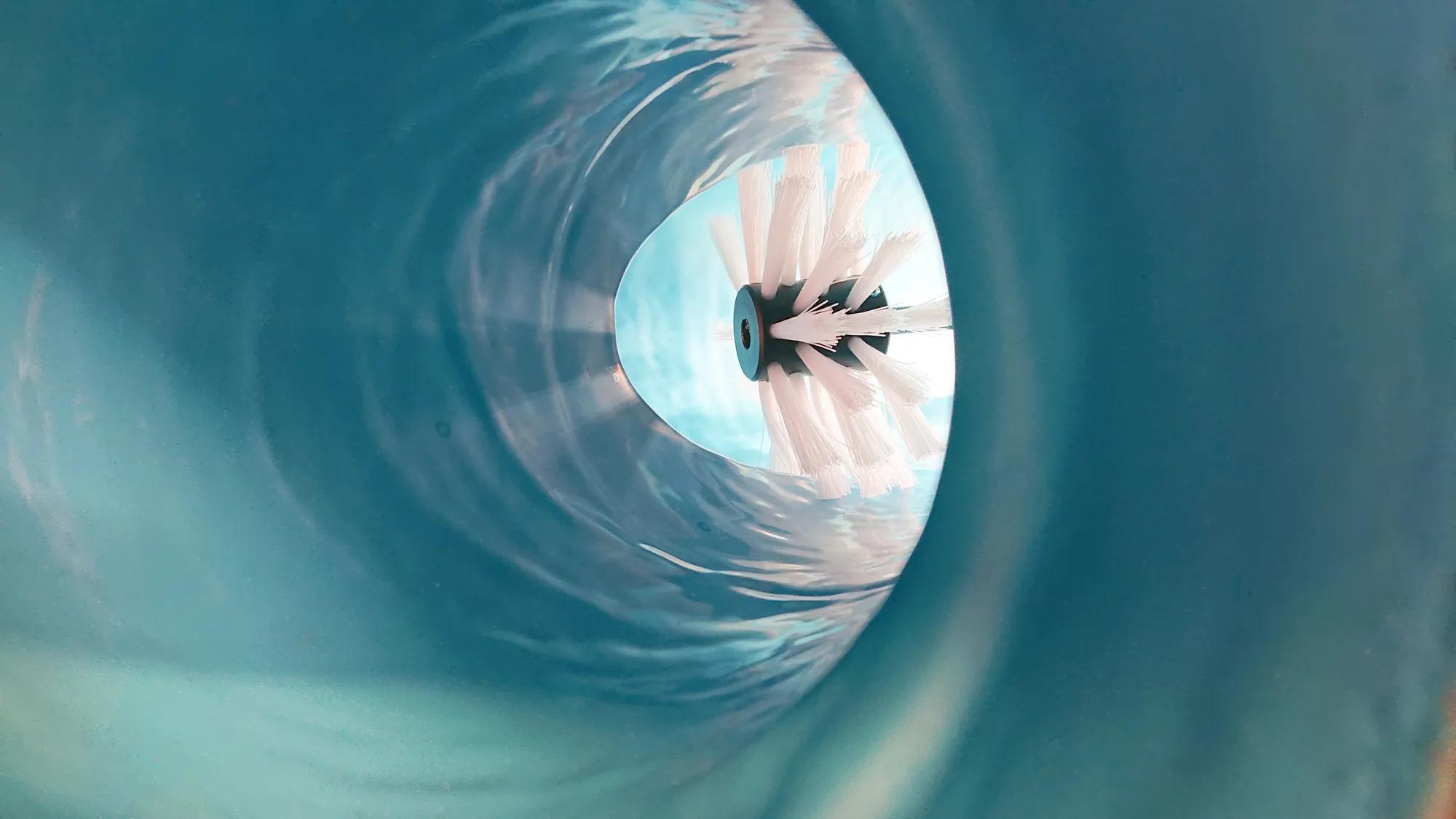 Brush coating in a lined pipe