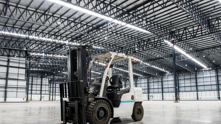 Forklift loader in large modern storehouse