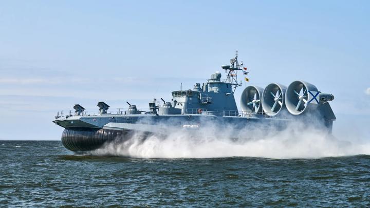Landing Craft Air Cushion LCAC hovercraft landing craft sailing splashing sea water at high speed. Hover craft flying above water, air cushion sailing near port at Baltic Sea. Russian Navy