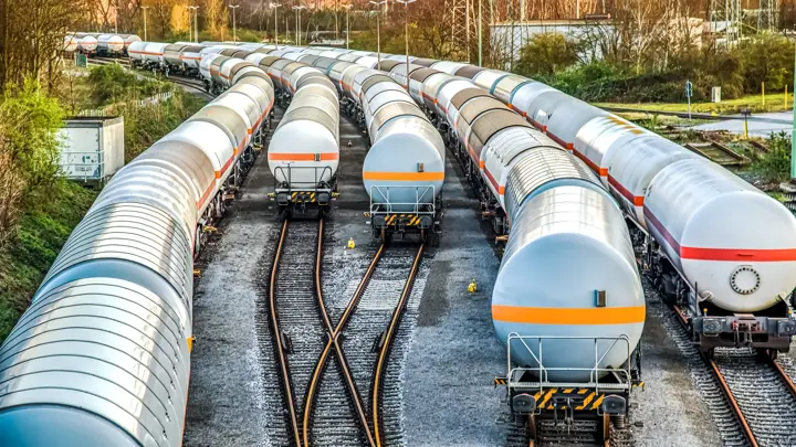 Freight train with petroleum tank-cars . terminal of freight cars . Transportation of liquid and dangerous goods by rail