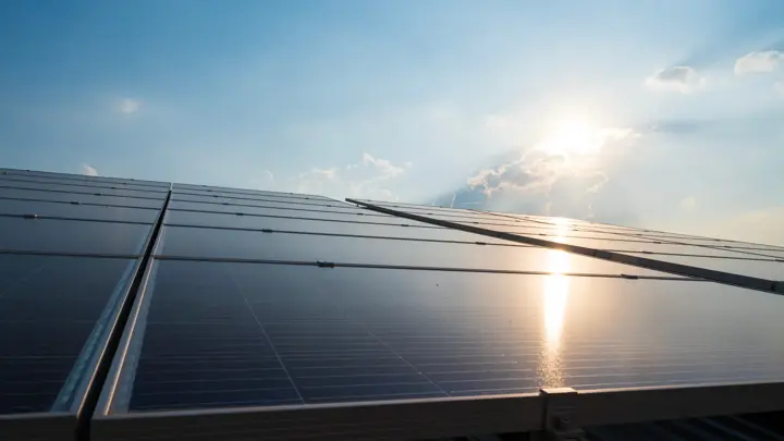 Solar panels and blue sky background.Solar cells farm on the roof.Photovoltaic modules for renewable energy.Save the earth and the energy with good environment concept.