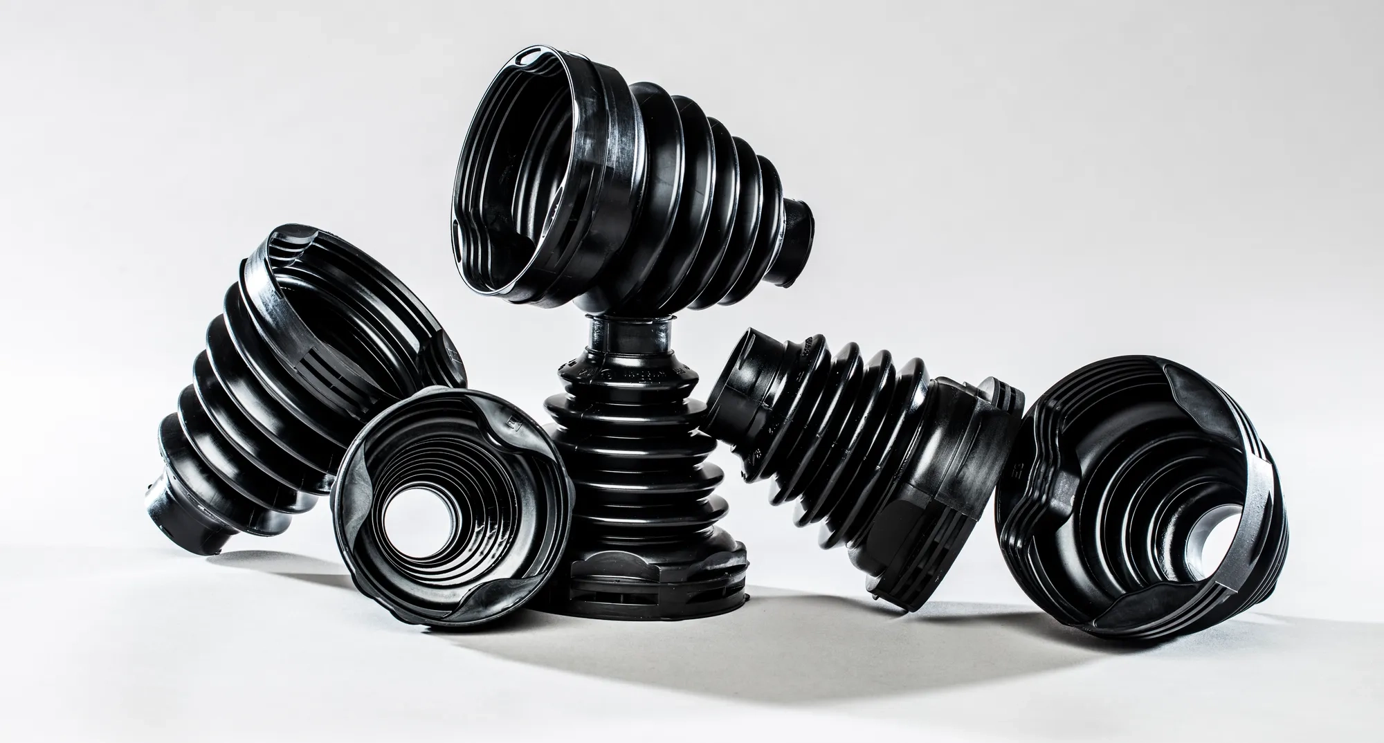 A selection of Trelleborg's Trilobe CVJ Boots is displayed against a white background. Crafted from TPE, these boots offer enhanced reliability, a compact design, and effortless assembly, making them a superior choice for performance and efficiency.