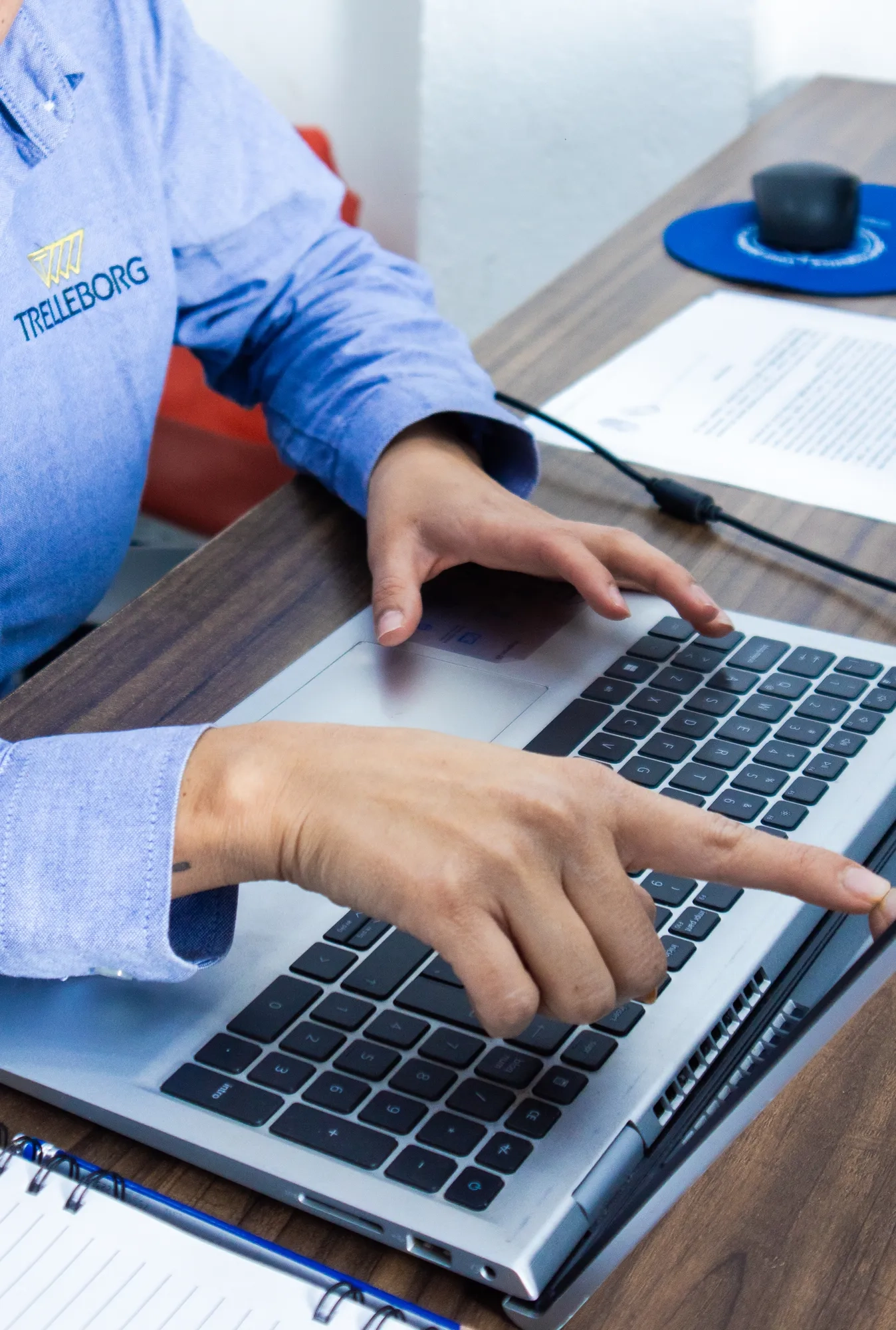 A Trelleborg employee showing information on her computer.
