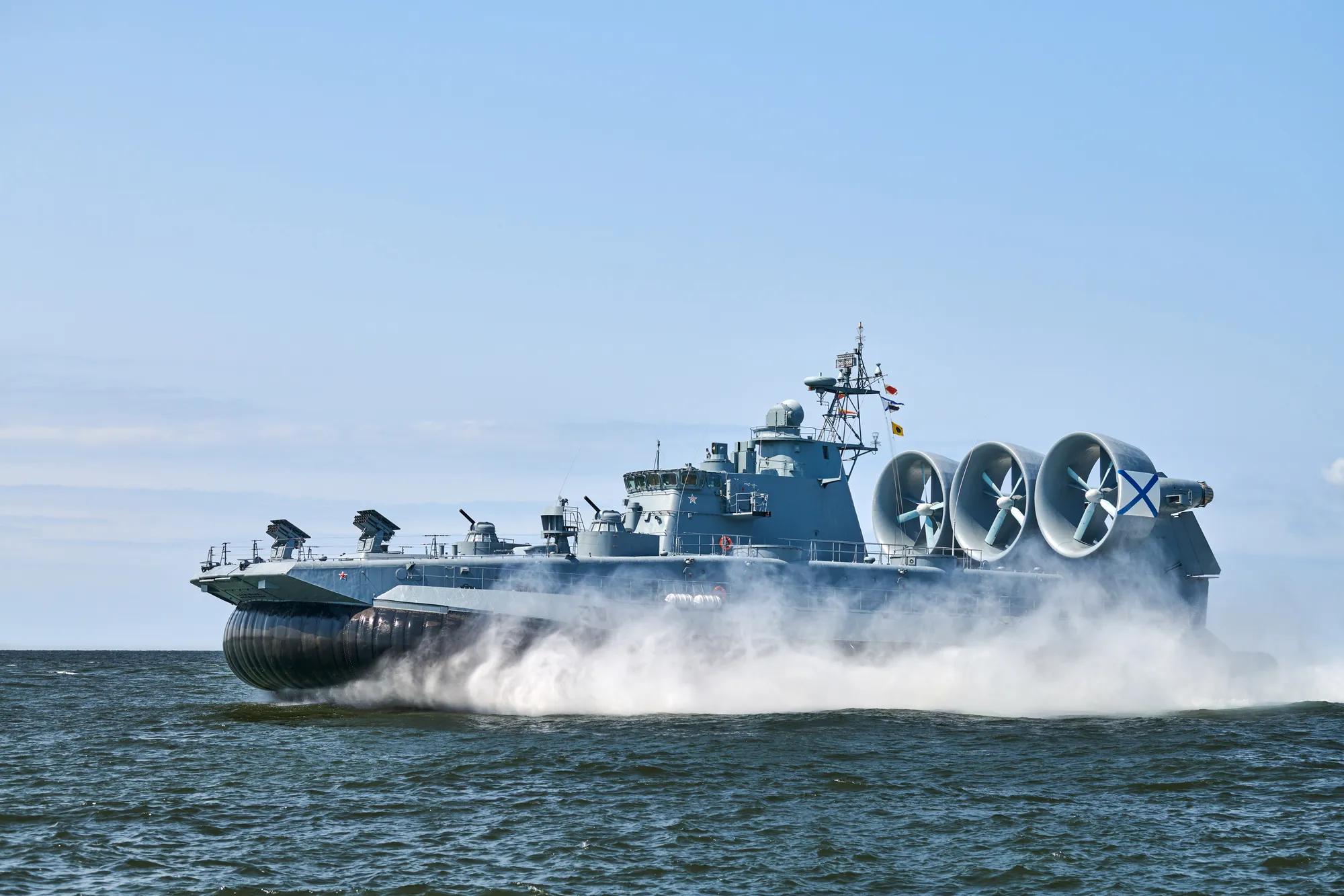 Landing Craft Air Cushion LCAC hovercraft landing craft sailing splashing sea water at high speed. Hover craft flying above water, air cushion sailing near port at Baltic Sea. Russian Navy