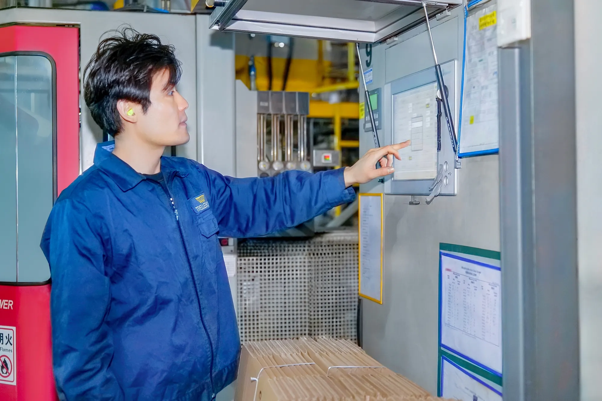 Trelleborg Boots' facility in Wuxi, an employee configures a machine to start a new production run of steering boots.