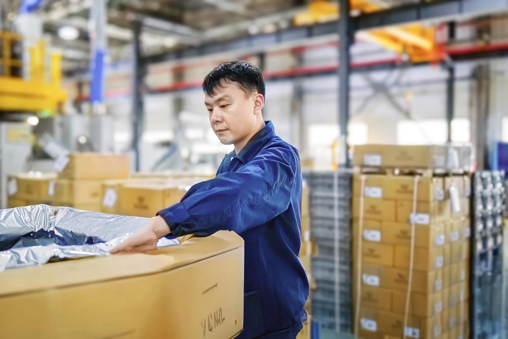 On the shop floor of our Chinese facility, an employee prepares the raw materials used in the production of bellows..