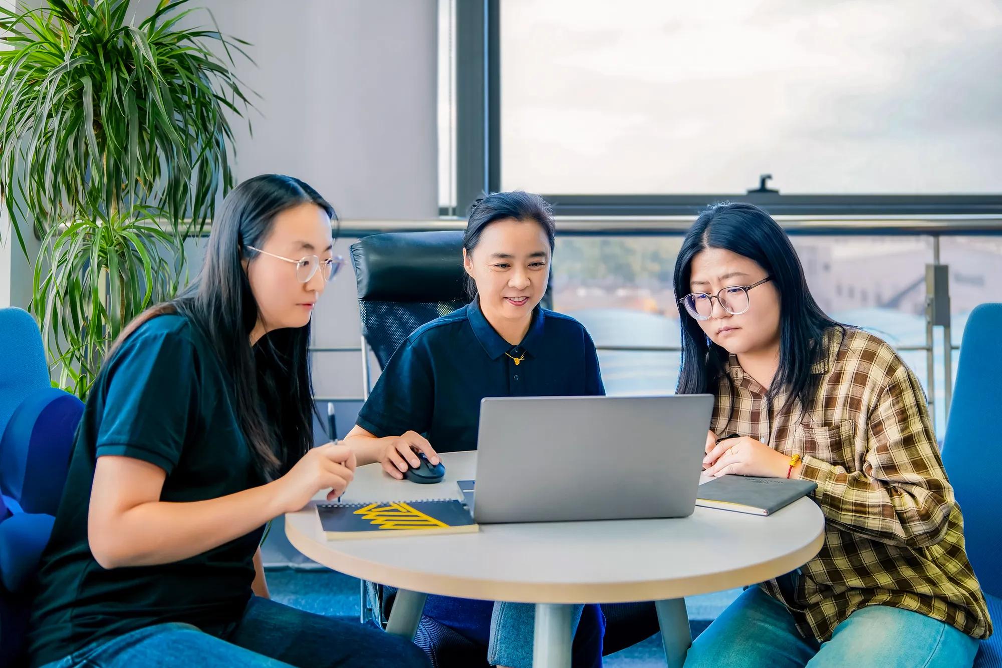 Three employees from the Trelleborg Boots facility in China connect with colleagues from other locations for a regular online meeting.