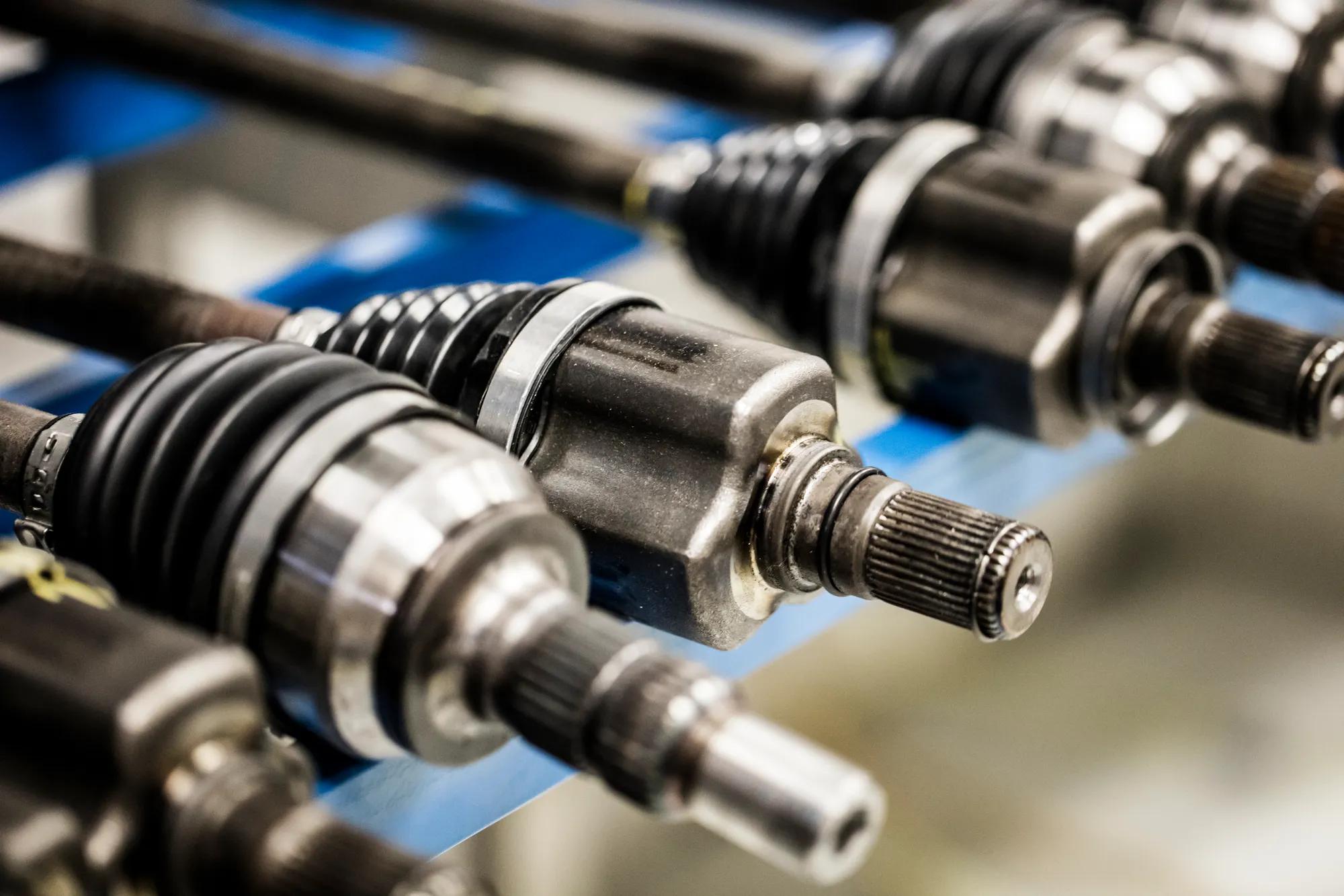 Multiple transmissions stored in the bench test area, ready for CVJ boot testing and product validation.