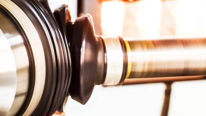 Constant Velocity Joint (CVJ) boot being tested on a high-temperature bench rig at an angle to evaluate its resistance to heat, rotation, and mechanical stress.