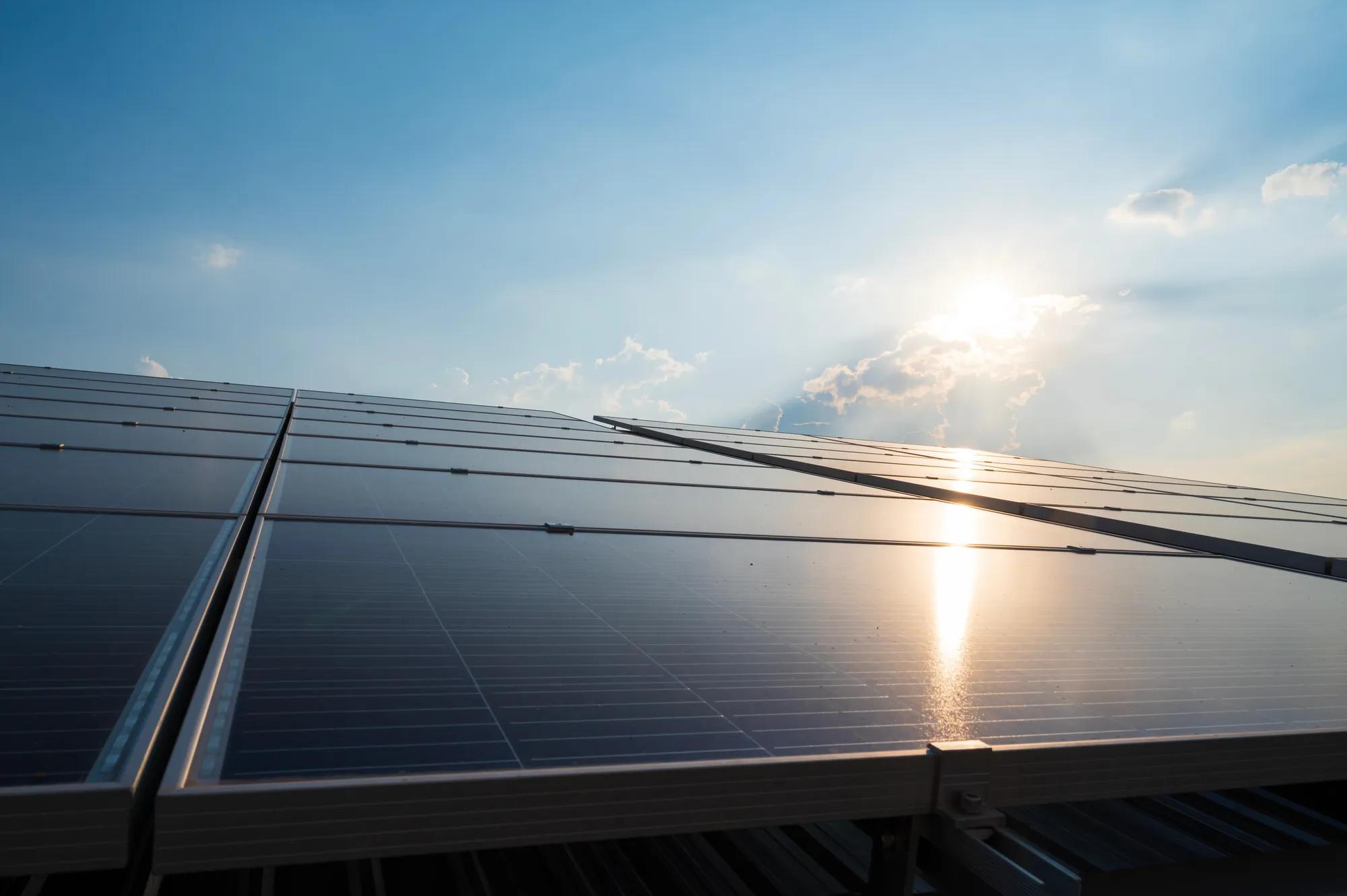 Solar panels and blue sky background.Solar cells farm on the roof.Photovoltaic modules for renewable energy.Save the earth and the energy with good environment concept.