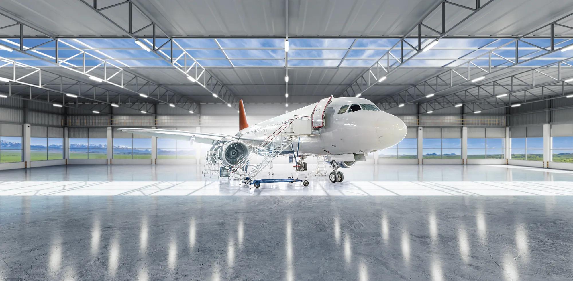 Aircraft under maintenance, checking mechanical systems for flight operations. Plane in the hangar.