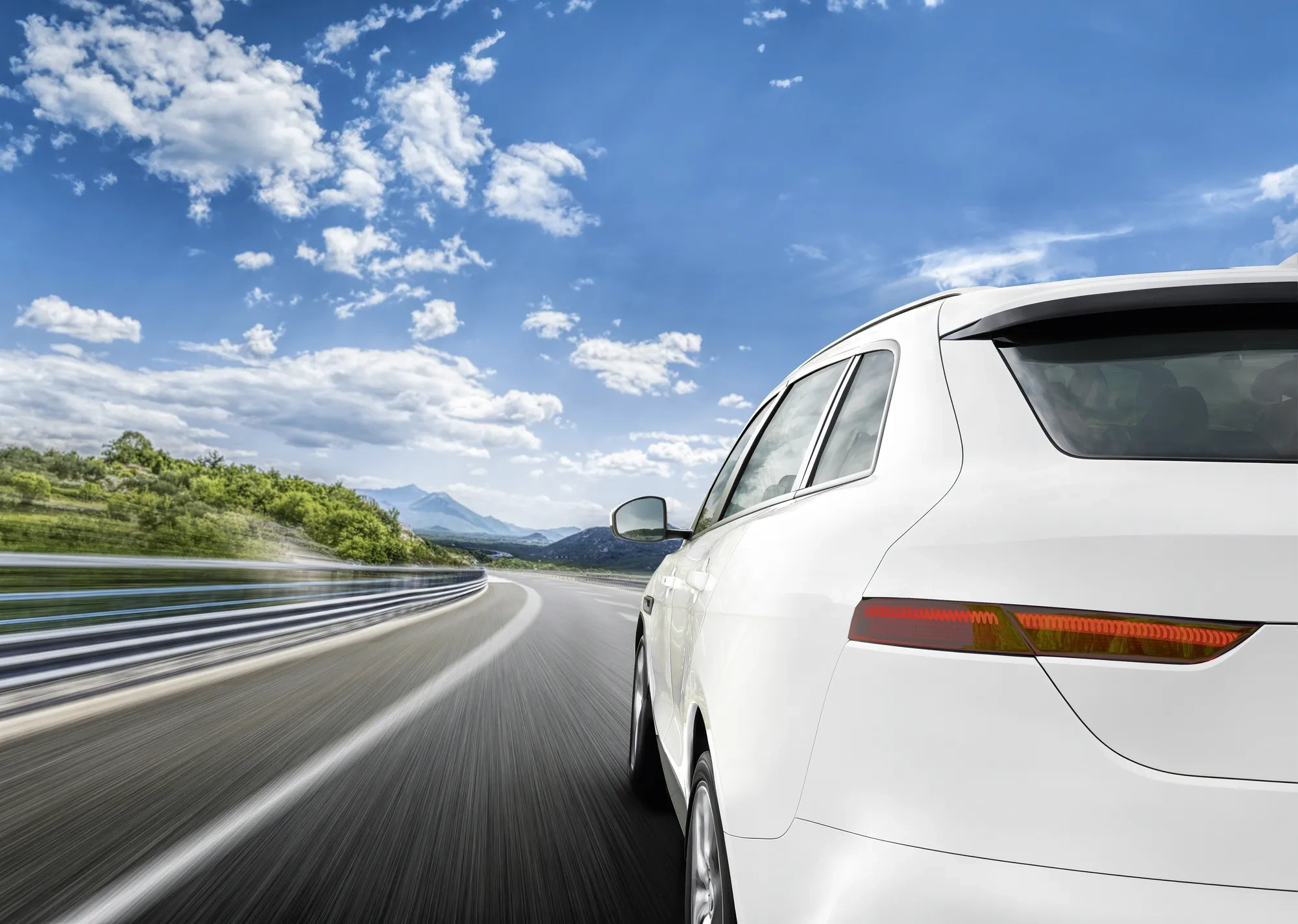 Red car rushing along a high-speed highway. Toned photo.
